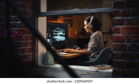 Creative Female 3D Architect Artist Using Desktop Computer with Screen Showing CAD Real Estate Project. Brazilian Woman Video Game Developer Creating Gaming Level. View Into the Apartment Window. - Powered by Shutterstock