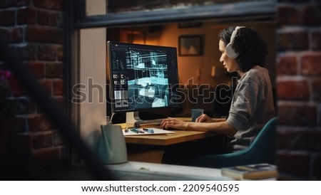 Creative Female 3D Architect Artist Using Desktop Computer with Display Showing CAD Real Estate Project. Brazilian Woman Video Game Developer Creating Gaming Level. View Into the Apartment Window.