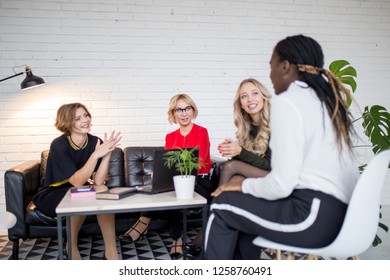 Creative female team woman collaborating, exchange phonenumbers and contacts, sharing useful information with each other, spend time together for common work.