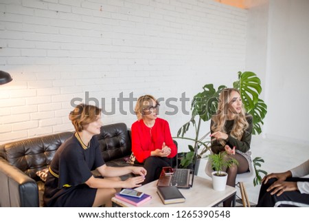 Creative female team woman collaborating, exchange phonenumbers and contacts, sharing useful information with each other, spend time together for common work.