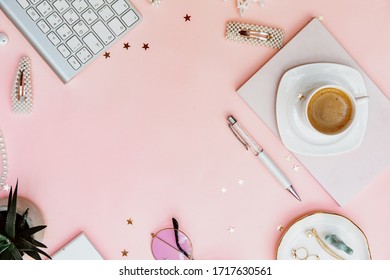 Creative Feminine workspace with notebook, cup of coffee, and accessories, blogger concept. Flat lay, top view.