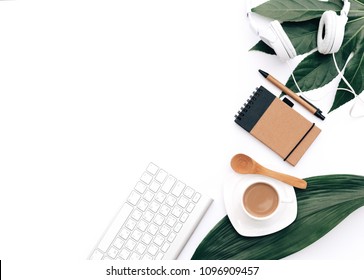 Creative flat lay background for blogger, keyboard, coffee cup and headphones with green leaves. Minimal workspace  - Powered by Shutterstock