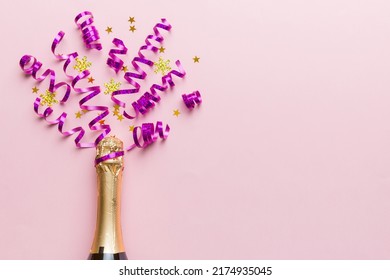 Creative flat lay composition with bottle of champagne and space for text on color background. Champagne bottle with colorful party streamers. holiday or christmas concept. - Shutterstock ID 2174935045