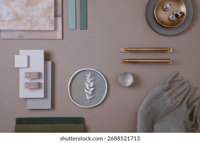 Creative flat lay composition of interior designer moodboard with textile and paint samples, panels and tiles. Beige, brown and green color palette. Copy space. Template.