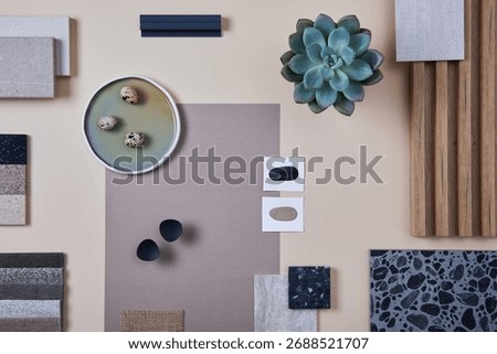 Creative flat lay composition of interior designer and architect moodboard. Textile and paint samples, lamella panels and lastrico tiles. Beige, black and green color palette. Copy space. Template.