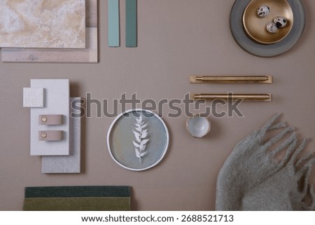 Creative flat lay composition of interior designer moodboard with textile and paint samples, panels and tiles. Beige, brown and green color palette. Copy space. Template.