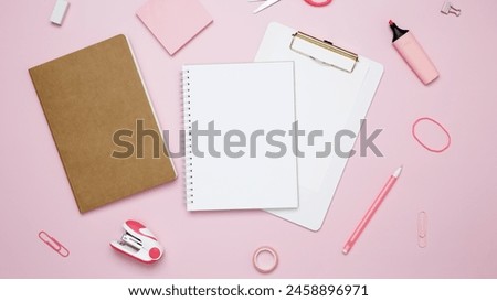 Creative flat lay mockup design of workspace. Top view composition with white notebook, to do list and stationery on pink background