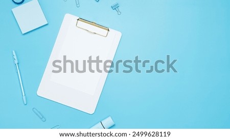 Creative flat lay mockup design of workspace. Top view composition with white notebook, to do list and stationery on blue background