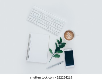 Creative Flat Lay Photo Of Workspace Desk With Smartphone, Keyboard, Coffee, Pencil, Leaves With Copy Space Background