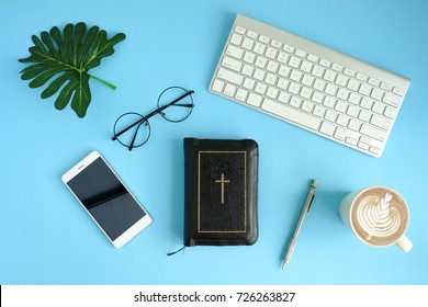 Creative Flat Lay Photo Of Workspace With Bible, Coffee,leaf,copy Space On Blue Background