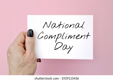 Creative flat lay top view of woman hands black manicure with paper page on pink background.national compliment day - Powered by Shutterstock