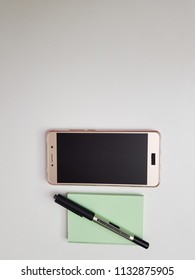 Creative flat lay of workspace, desk with paper notebook, smartphone, pen with copy space. desktop, workplace freelancer and copywriter. place for text