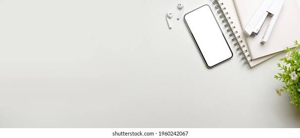Creative flat lay workspace with smartphone, stationery, accessories and copy pace, top view, clipping path