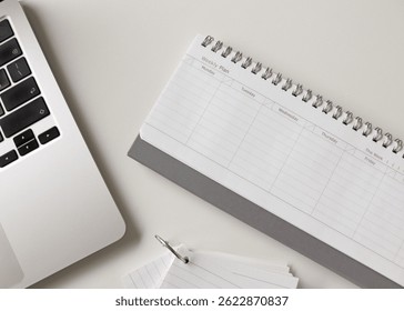 Creative flat lay of workspace with weekly planner, laptop, stationery, coffee cup and copy space in home office