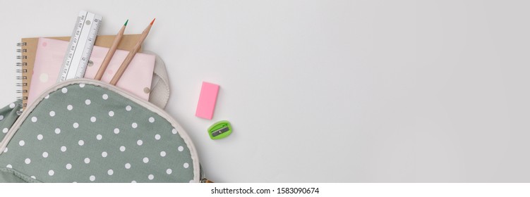 Creative Flatlay Of Education White Table With Backpack, Student Books, Colorful Pencil, Empty Space In Studio Shot Isolated On White Long Banner Background, Concept Of Education And Back To School