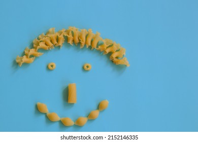 Creative Food Concept, Cute Face With Smile Made From And Italian Pasta, Top View