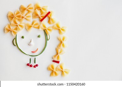 creative food concept, cute girls's face made of ripe vegetables and Italian farfalle pasta - Powered by Shutterstock