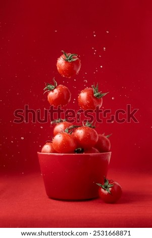 Creative food concept. Tomatoes pattern. Flying red ripe juicy cherry tomatoes with water drops on red background. Healthy fresh vegan organic food, vegetable, summer, harvesting