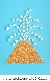 Creative Food Concept With Volcano Eruption Shape Made Of Popcorn On Pastel Blue Background. Flat Lay Design