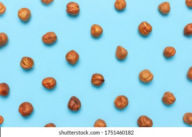 Creative Food Layout. Hazelnuts On Blue Background Top View Copy Space. Concept Of Food, Healthy Nutrition, Nut, Healthy Fats. Hazelnut Flat Lay. Walnut Pattern. Organic Healthy Vegan Snack