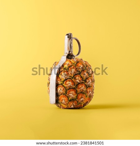 Creative fruit concept. Pineapple shaped pomegranate with fuse on yellow background. 
