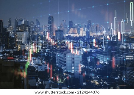 Creative glowing forex chart grid and big data hologram on blurry night city background. Trade, technology and finance concept. Double exposure