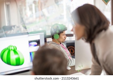 Creative graphic designers working at computers in office - Powered by Shutterstock