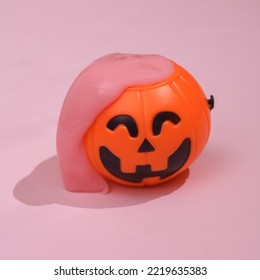 Creative Halloween Layout, Bucket With Slime On Pink Background With Shadow. Visual Trend. Fresh Idea. Concept Pop. Trick Or Treat