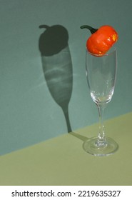 Creative Halloween Layout, Cocktail Glass With Pumpkin On Two Tone Green Background. Visual Trend. Trick Or Treat