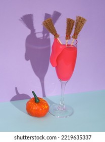 Creative Halloween Layout, Cocktail Glass With Neon Slime And Halloween Decor On Two Tone Background With Shadow. Visual Trend. Trick Or Treat