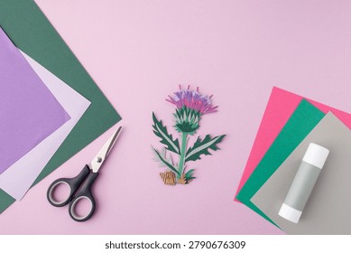 Creative handcraft material kit layout with vibrant sheets, tools, finished paper flower. Useful for craft kit package front page, educational publishing houses, design agency portfolios
