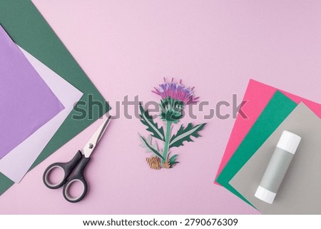 Creative handcraft material kit layout with vibrant sheets, tools, finished paper flower. Useful for craft kit package front page, educational publishing houses, design agency portfolios