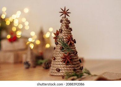 A creative handmade Christmas tree made of a cardboard cone, wrapped with rope and decorated with coffee beans and a anise.Christmas,New Year and eco-friendly concept.Selective focus,copy space. - Powered by Shutterstock