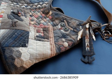 Creative handmade patchwork bag with quilted texture and folk art style. This unique accessory features whimsical doll charm, showcasing love for traditional craft
