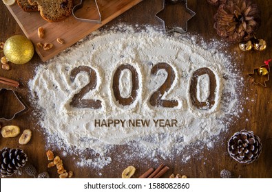 Creative Happy New Year 2020 Greeting Card For Home Baker, Baking, Numbers Made Out Of Flour, With Letters, Top View