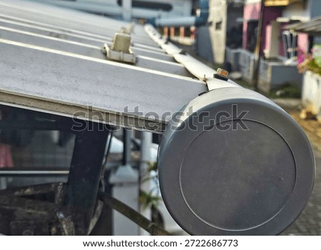 Creative home modification using PVC pipe as a rain gutter system. Close-up of improvised water drainage solution for residential buildings, showcasing practical DIY and recycling ideas.