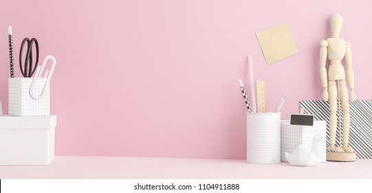 Creative Home Office Desk With School Supplies And Pink Wall.