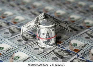 A Creative House Built with Stacked Dollar Bills. A house made out of dollar bills sitting on top of each other - Powered by Shutterstock