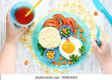 Creative Idea For Baby Morning Breakfast. Funny Chick Egg Colorful Vegetables Fresh Tomato Juice Rice Garnish. Concept Of Healthy Food For Children Top View