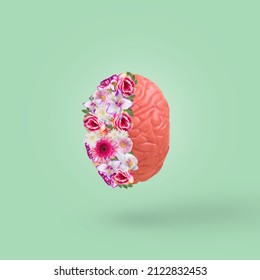 Creative idea with brain and colorful flowers isolated on a pastel green background. Minimal concept of calm, mental health, emotional wellness. - Shutterstock ID 2122832453