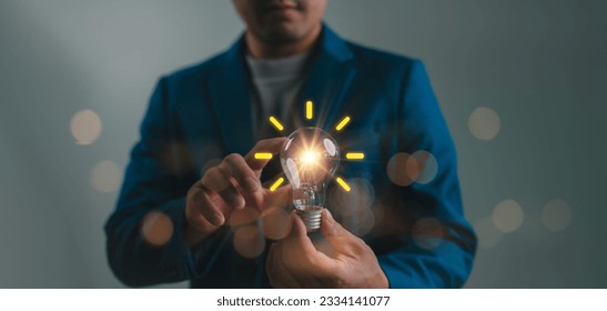 Creative idea. Concept of idea and innovation, Businessman holding light bulb. Idea concept with innovation and inspiration for business or education, Creative thinking and learning. - Powered by Shutterstock