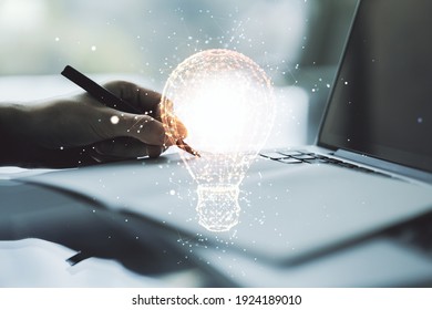 Creative Idea Concept With Light Bulb Illustration And Hand Writing In Notebook On Background With Laptop. Multiexposure