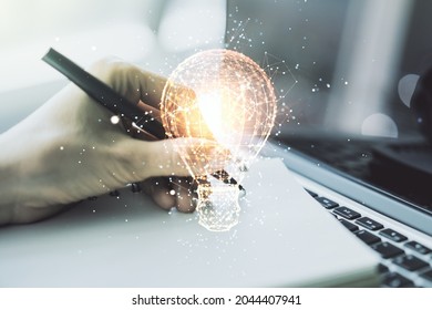 Creative Idea Concept With Light Bulb Illustration And Hand Writing In Notebook On Background With Laptop. Multiexposure