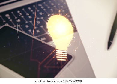 Creative idea concept with light bulb illustration on modern laptop background. Multiexposure