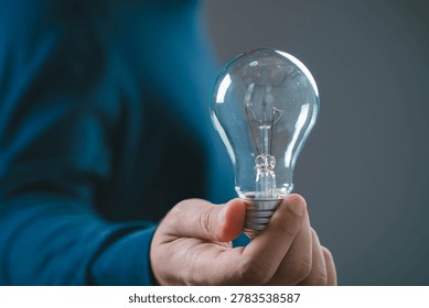 Creative idea concept with light bulb in hand, symbol of innovation inspiration and solution thinking, business creativity, problem solving, startup idea and bright vision for success