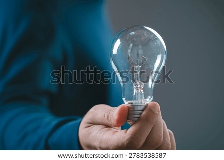 Creative idea concept with light bulb in hand, symbol of innovation inspiration and solution thinking, business creativity, problem solving, startup idea and bright vision for success