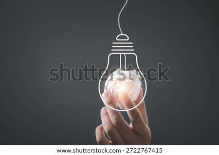 Creative idea with human hand holding crumpled paper inside glowing light bulb outline, symbolizing innovation, problem solving, inspiration, creativity, startup thinking, and modern business ideas.