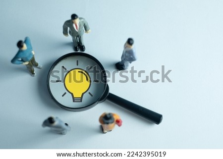 Creative idea and innovation,,New ideas,Education Concept.,Group of Business people looking magnifying glass with light bulb icon over white background.