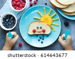 Creative idea for kid breakfast - sweet bread bun cloud with berry rain and fruit sun