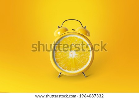 Creative idea layout fresh orange slice alarm clock on orange background. minimal idea business concept. fruit idea creative to produce work within an advertising marketing communications. Summer